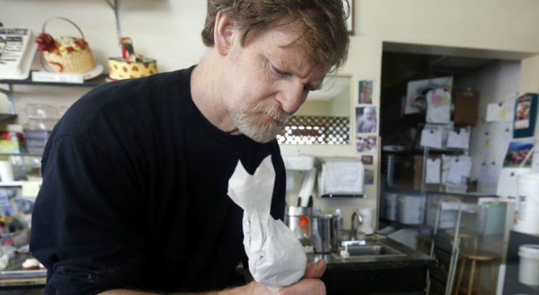 In this March 10, 2014, file photo, Masterpiece Cakeshop owner Jack Phillips decorates a cake inside his store in Lakewood, Colo. Masterpiece Cakeshop owner Jack Phillips