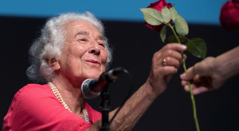 In this Sept. 15, 2016 file photo British writer Judith Kerr holds a rose in Berlin, Germany. Judith Kerr, author and illustrator of the bestselling "The Tiger Who Came to Tea" and other beloved children's books, has died at the age of 95. In this Sept. 15, 2016 file photo British writer Judith Kerr holds a rose in Berlin, Germany. Judith Kerr, author and illustrator of the bestselling "The Tiger Who Came to Tea" and other beloved children's books, has died at the age of 95.