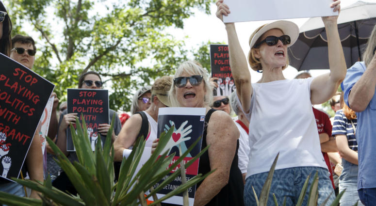 People at the Keep Families Together rally, including Marsha Gore, right, and Claudia Short, cheer as the son of Holocaust survivors speaks about the importance of offering asylum in the South Plaza of the Oklahoma State Capitol Building in Oklahoma City. People at the Keep Families Together rally, including Marsha Gore, right, and Claudia Short, cheer as the son of Holocaust survivors speaks about the importance of offering asylum in the South Plaza of the Oklahoma State Capitol Building in Oklahoma City.