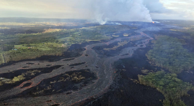 This Wednesday, June 6, 2018 photo from the U.S. Geological Survey shows Kilauea's lower East Rift Zone, showing continued fountaining of a fissure and the lava flow channel fed by it near the town of Kapoho on the island of Hawaii. Kilauea's lower East Rift Zone, showing continued fountaining of a fissure and the lava flow channel fed by it