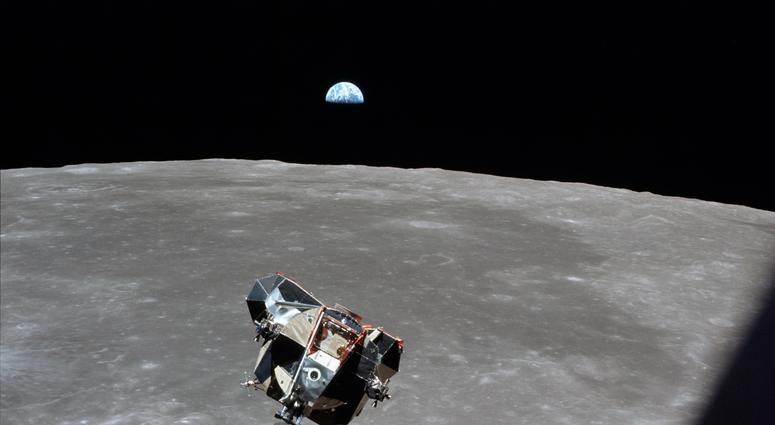 Astronaut Mike Collins captures Earth, the moon, the Eagle, and the edge of the Command Module's window in a single shot. Astronaut Mike Collins captures Earth, the moon, the Eagle, and the edge of the Command Module's window in a single shot.