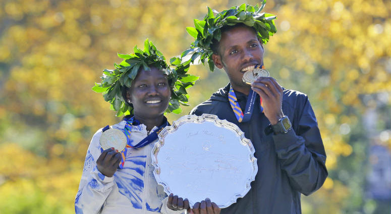 First place finishers Mary Keitany of Kenya, left, and Lelisa Desisa of Ethiopia pose for a picture at the finish line of the New York City Marathon in New York, Sunday, Nov. 4, 2018.