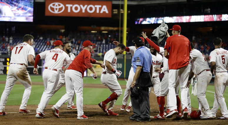 Philadelphia Phillies' Trevor Plouffe, second from right, celebrates with teammates. Philadelphia Phillies' Trevor Plouffe, second from right, celebrates with teammates.