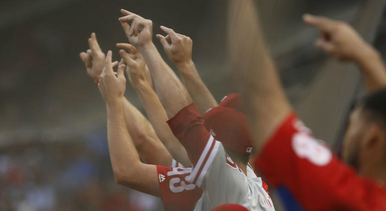 The Philadelphia Phillies snap their fingers as a run scores against the Boston Red Sox in the second inning at Fenway Park. The Philadelphia Phillies snap their fingers as a run scores against the Boston Red Sox in the second inning at Fenway Park.