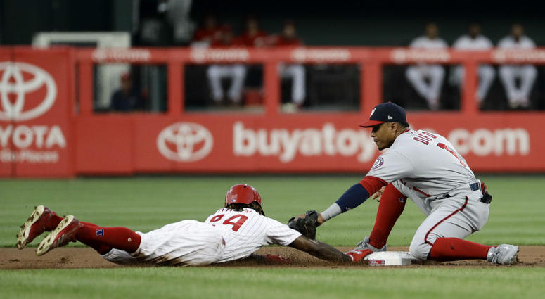 Philadelphia Phillies' Roman Quinn, left, dives safely back to second base under the tag from Washington Nationals shortstop Wilmer Difo on a pickoff attempt during the first inning of a baseball game, Wednesday, Aug. 29, 2018, in Philadelphia. Philadelphia Phillies' Roman Quinn, left, dives safely back to second base under the tag from Washington Nationals shortstop Wilmer Difo on a pickoff attempt during the first inning of a baseball game, Wednesday, Aug. 29, 2018, in Philadelphia.