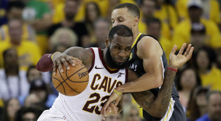 Golden State Warriors guard Stephen Curry, right, shoots against Cleveland Cavaliers forward Kevin Love (0) during the first half of Game 2 of basketball's NBA Finals in Oakland, Calif., Sunday, June 3, 2018. Golden State Warriors guard Stephen Curry, right, shoots against Cleveland Cavaliers forward Kevin Love (0)