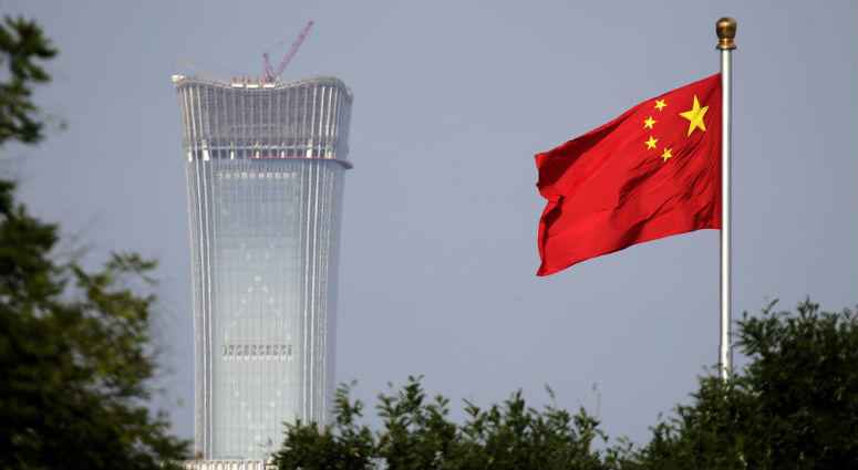 In this Thursday, June 14, 2018, file photo, a Chinese national flag at Tiananmen Square flutters against the capital city tallest skyscraper China Zun Tower under construction at the Central Business District in Beijing. In this Thursday, June 14, 2018, file photo, a Chinese national flag at Tiananmen Square flutters against the capital city tallest skyscraper China Zun Tower under construction at the Central Business District in Beijing.
