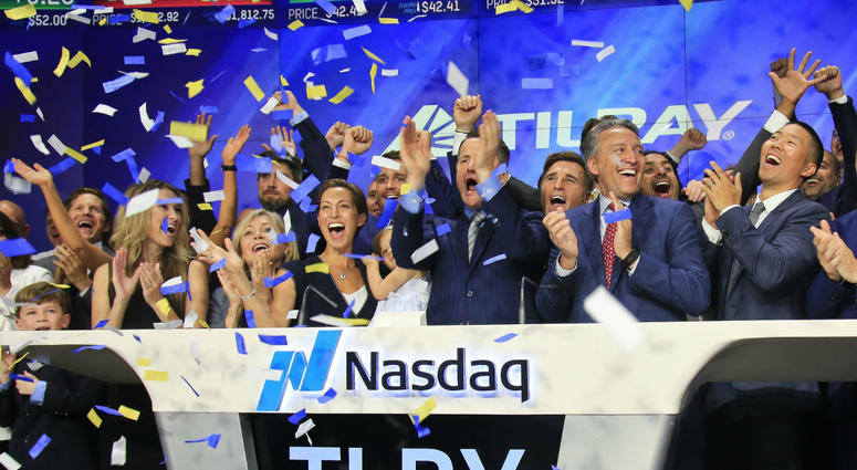 In this July 19, 2018, file photo Brendan Kennedy, third from right in front, CEO and founder of British Columbia-based Tilray Inc., a major Canadian marijuana grower, leads cheers as confetti falls to celebrate his company's IPO. In this July 19, 2018, file photo Brendan Kennedy, third from right in front, CEO and founder of British Columbia-based Tilray Inc., a major Canadian marijuana grower, leads cheers as confetti falls to celebrate his company's IPO.