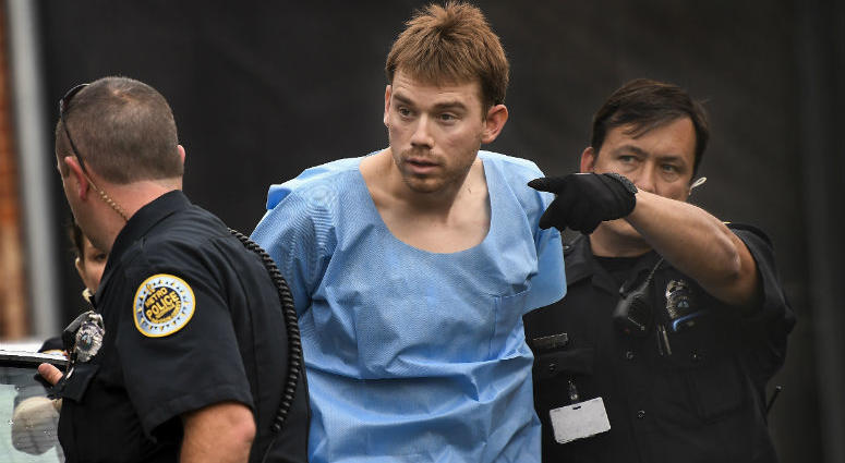 In this Monday, April 23, 2018 photo, Travis Reinking, suspected of killing four people in a late-night shooting at a Waffle House restaurant, is escorted into the Hill Detention Center in Nashville. Travis Reinking is escorted into the Hill Detention Center in Nashville