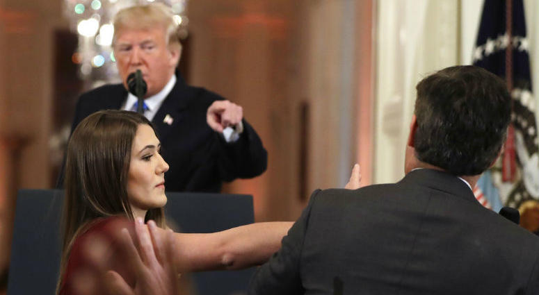 As President Donald Trump points to CNN's Jim Acosta, a White House aide takes the microphone from him during a news conference in the East Room of the White House, Wednesday, Nov. 7, 2018, in Washington.