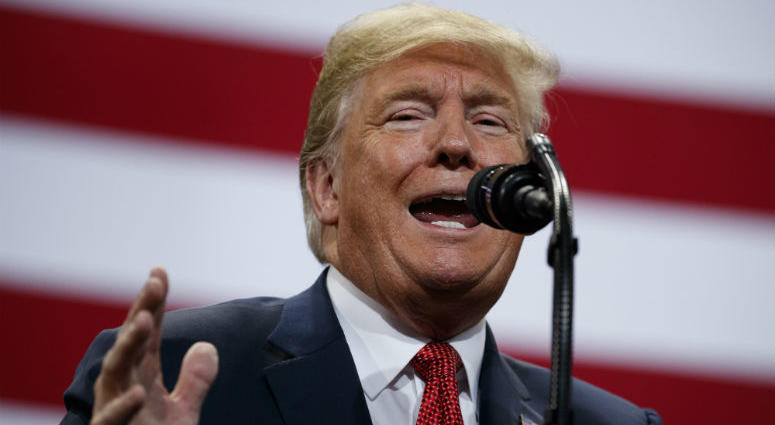 President Donald Trump waves from the top of the steps of Air Force One at Andrews Air Force Base in Md., Wednesday, Oct. 31, 2018. Trump is heading to Fort Myers, Fla. to speak at a rally.