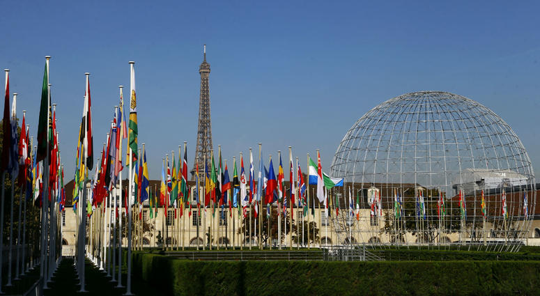 In this Tuesday Oct. 31, 2017 file picture, the Eiffel Tower, country flags and the Dome are seen from the garden of the UNESCO headquarters in Paris, France. In this Tuesday Oct. 31, 2017 file picture, the Eiffel Tower, country flags and the Dome are seen from the garden of the UNESCO headquarters in Paris, France.