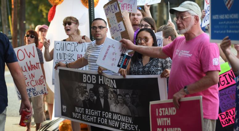 A group hold a pop-up protest outside of the Railyard Tavern in Fair Lawn on Aug. 6, 2018, where Bob Hugin, the Republican nominee, who is trying to unseat U.S. Sen. Bob Menendez in the November election, is holding a Girls Night Out fundraiser. New Jersey Senate protest