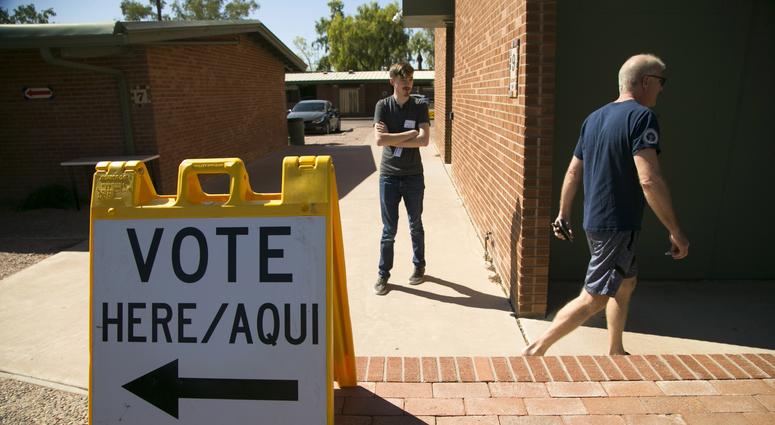 August 28, 2018; Scottsdale, AZ, USA: Roger Baker (right) of Scottsdale, walks back to his vehicle after voting for the primary, at the polling place at the Paiute Neighborhood Center. August 28, 2018; Scottsdale, AZ, USA: Roger Baker (right) of Scottsdale, walks back to his vehicle after voting for the primary, at the polling place at the Paiute Neighborhood Center.