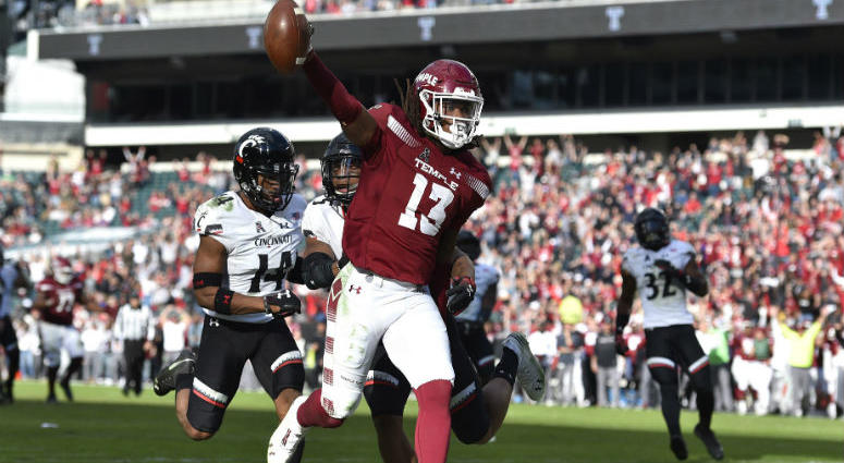 Oct 20, 2018; Philadelphia, PA, USA; Temple Owls wide receiver Isaiah Wright (13) celebrates in the end zone after scoring a touchdown past Cincinnati Bearcats cornerback Cameron Jefferies (14) and safety Darrick Forrest (5) during overtime. Temple Owls wide receiver Isaiah Wright (13) celebrates in the end zone after scoring a touchdown past Cincinnati Bearcats cornerback Cameron Jefferies (14) and safety Darrick Forrest (5) during overtime.