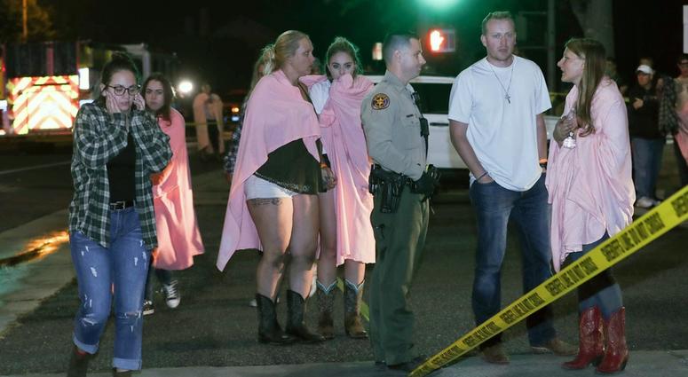 People comfort each other at the scene of a mass shooting at the Borderline Bar and Grill in Thousand Oaks, Calif., Nov. 8, 2018. People comfort each other at the scene of a mass shooting at the Borderline Bar and Grill in Thousand Oaks, Calif., Nov. 8, 2018.