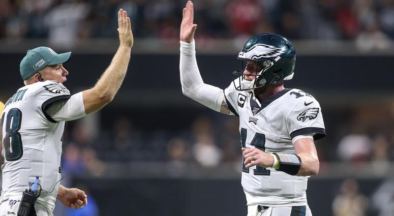 Sep 15, 2019; Atlanta, GA, USA; Philadelphia Eagles quarterback Carson Wentz (11) celebrates after a touchdown with quarterback Josh McCown (18) against the Atlanta Falcons in the fourth quarter at Mercedes-Benz Stadium. Philadelphia Eagles quarterback Carson Wentz (11) celebrates after a touchdown with quarterback Josh McCown (18) against the Atlanta Falcons in the fourth quarter at Mercedes-Benz Stadium.