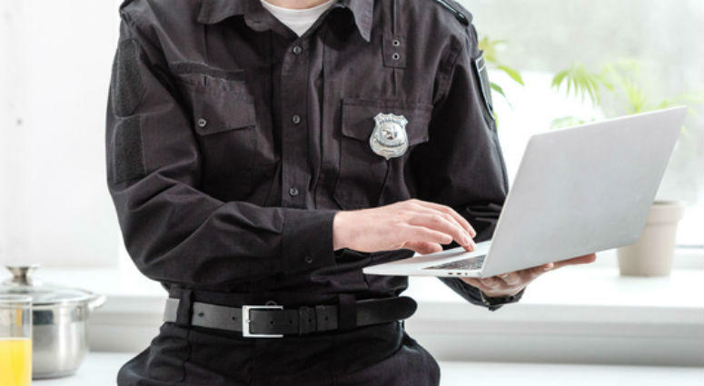 File photo of police officer using laptop computer. Police Laptop