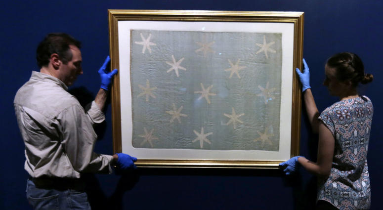 Collections manager Michelle Moskal, right, and curator Mark Turdo hang the Commander-in-Chief's Standard, Wednesday, June 13, 2018, at an exhibition gallery in the Museum of the American Revolution in Philadelphia. Collections manager Michelle Moskal, right, and curator Mark Turdo hang the Commander-in-Chief's Standard, Wednesday, June 13, 2018, at an exhibition gallery in the Museum of the American Revolution in Philadelphia.