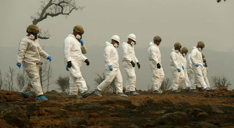 Members of the California Army National Guard search a property for human remains at the Camp fire, Wednesday, Nov. 14, 2018, in Paradise, Calif.