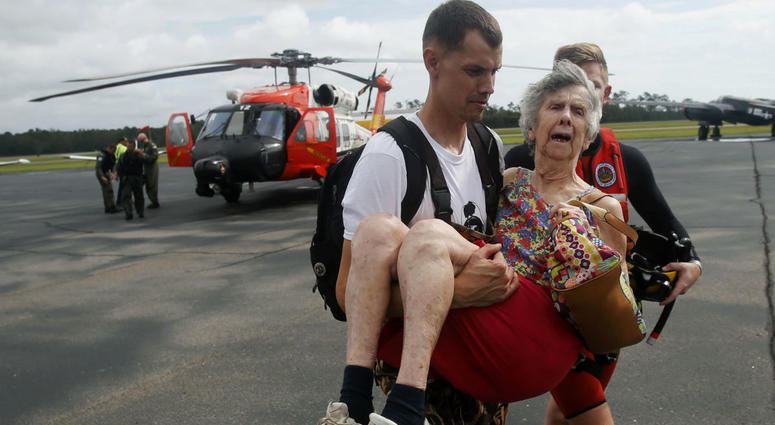 An unidentified family member carries Ruth Brady to safety at the Wilmington airport in Wilmington, N.C., Monday, Sept. 17, 2018. An unidentified family member carries Ruth Brady to safety at the Wilmington airport in Wilmington, N.C., Monday, Sept. 17, 2018.