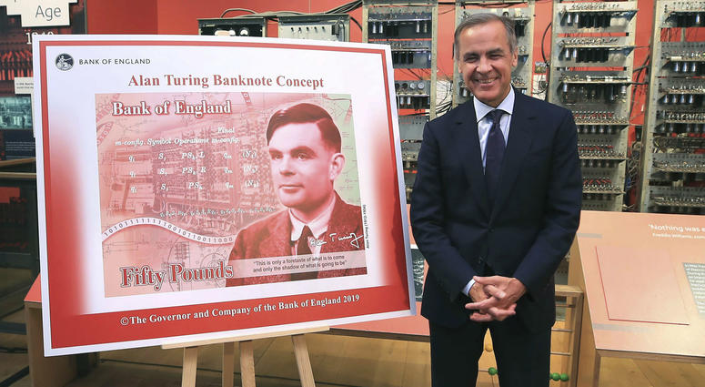 Governor of the Bank of England, Mark Carney poses for a photo with the artwork for the concept of the new 50 pound notes, after announcing that Second World War code-breaker Alan Turing has been selected to feature on the new notes. Governor of the Bank of England, Mark Carney poses for a photo with the artwork for the concept of the new 50 pound notes, after announcing that Second World War code-breaker Alan Turing has been selected to feature on the new notes.