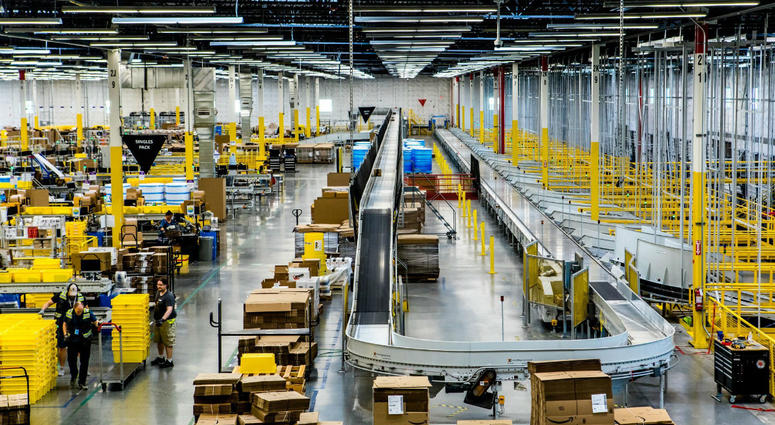 Inside an Amazon fulfillment center, a conveyer belt is used to organize packages. Amazon Fulfillment Center