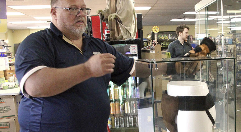 In this May 2, 2018 file photo, Blockbuster Alaska general manager Kevin Daymude moves a display case featuring the jockstrap worn by actor Russell Crowe in the 2005 movie "Cinderella Man" at a Blockbuster video store in Anchorage, Alaska. In this May 2, 2018 file photo, Blockbuster Alaska general manager Kevin Daymude moves a display case featuring the jockstrap worn by actor Russell Crowe in the 2005 movie "Cinderella Man" at a Blockbuster video store in Anchorage, Alaska.
