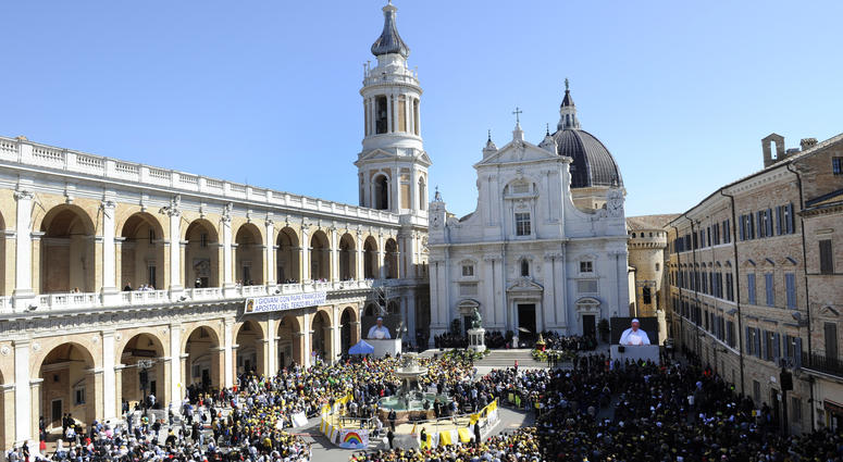 Pope Francis seen on a giant screen at right, celebrates Mass outside Loreto's cathedral, central Italy, Monday, March 25, 2019. Pope Francis seen on a giant screen at right, celebrates Mass outside Loreto's cathedral, central Italy, Monday, March 25, 2019.