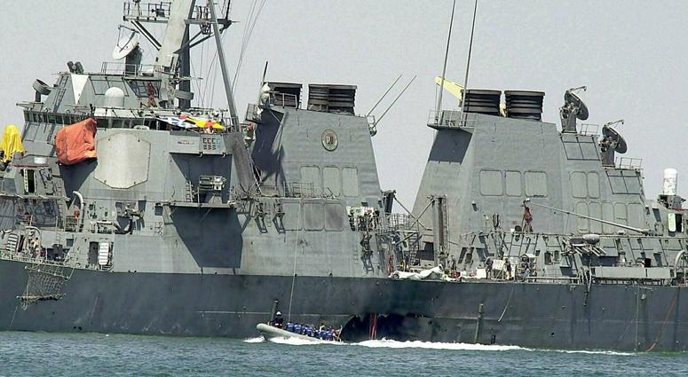 In this Oct. 15, 2000 file photo, experts in a speed boat examine the damaged hull of the USS Cole at the Yemeni port of Aden after an al-Qaida attack that killed 17 sailors. In this Oct. 15, 2000 file photo, experts in a speed boat examine the damaged hull of the USS Cole at the Yemeni port of Aden after an al-Qaida attack that killed 17 sailors.