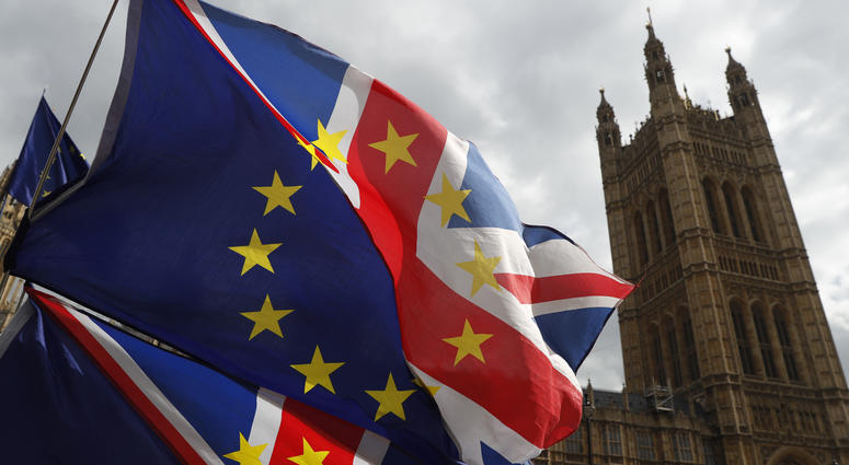Anti Brexit protesters hold onto their flags and placards as they demonstrate outside the Houses of Parliament in London, Tuesday, March 26, 2019. Anti Brexit protesters hold onto their flags and placards as they demonstrate outside the Houses of Parliament in London, Tuesday, March 26, 2019.