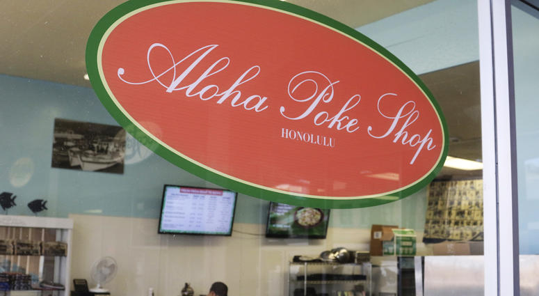 This Tuesday, April 16, 2019, photo shows Aloha Poke Shop, a store in Honolulu that received a letter from Chicago-based Aloha Poke Co. saying the Illinois company had trademarked "Aloha Poke" and the Hawaii company would need to change its name Hawaii lawmakers are considering adopting a resolution calling for the creation of legal protections for Native Hawaiian cultural intellectual property.
