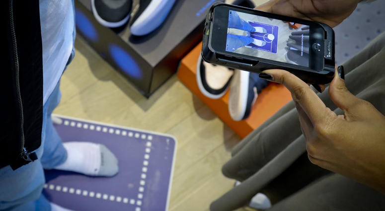 Nike officials demonstrate the company's foot-scanning tool on its app that will measure and remember the length, width and other dimensions of customers' feet after they point a smartphone camera to their toes, Wednesday April 24, 2019, in New York. Nike officials demonstrate the company's foot-scanning tool on its app that will measure and remember the length, width and other dimensions of customers' feet after they point a smartphone camera to their toes, Wednesday April 24, 2019, in New York.