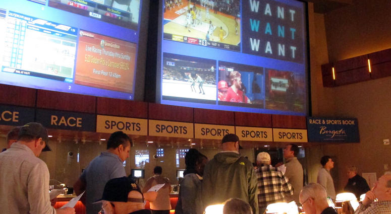 FILE - In this March 21, 2019, file photo, gamblers line up to place bets on the NCAA men's college basketball tournament at the Borgata casino in Atlantic City N.J. This is the first March Madness tournament since legal gambling expanded last year in the U.S. The spread of legalized sports betting is largely following regional boundaries.