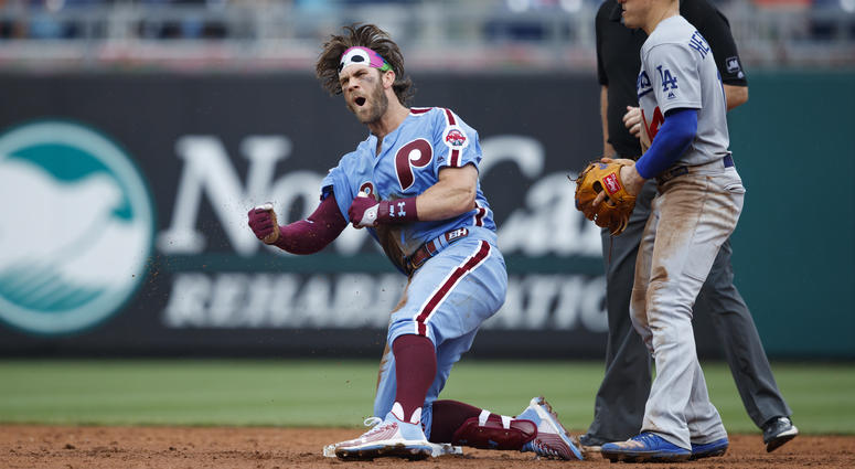 Philadelphia Phillies' Bryce Harper, left, celebrates past Los Angeles Dodgers shortstop Enrique Hernandez after hitting an RBI-single during the eighth inning of a baseball game, Thursday, July 18, 2019, in Philadelphia. Philadelphia won 7-6. Philadelphia Phillies' Bryce Harper, left, celebrates past Los Angeles Dodgers shortstop Enrique Hernandez after hitting an RBI-single during the eighth inning of a baseball game, Thursday, July 18, 2019, in Philadelphia. Philadelphia won 7-6.