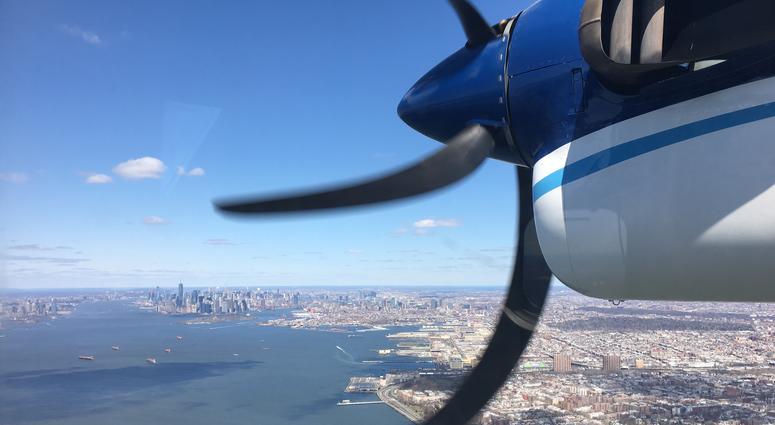 In this 2018 photo, a Twin Otter aircraft flies over New York Harbor and New York City on a research mission. In older Eastern US cities, nine times as much natural gas is leaking out of pipelines, homes than federal government had thought.