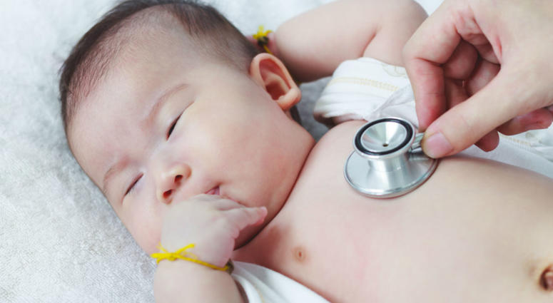 A doctor checks a baby with a stethoscope A doctor checks a baby with a stethoscope