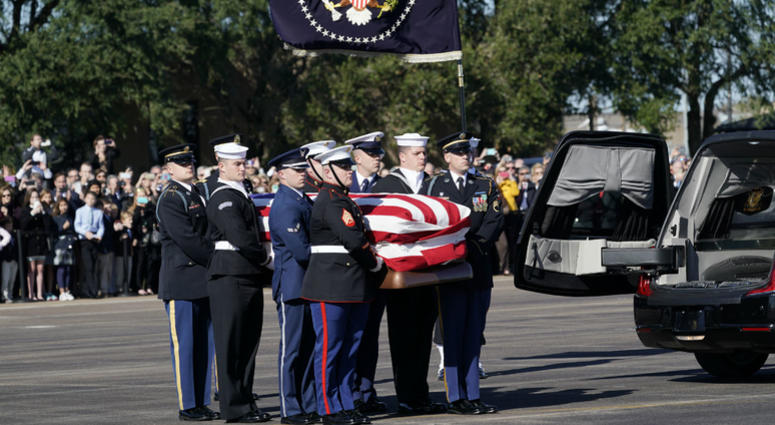 The flag-draped casket of former President George H.W. Bush is carried by a joint services military honor guard to Special Air Mission 41 at Ellington Field during a departure ceremony Monday, Dec. 3, 2018, in Houston. The flag-draped casket of former President George H.W. Bush is carried by a joint services military honor guard to Special Air Mission 41 at Ellington Field during a departure ceremony Monday, Dec. 3, 2018, in Houston.