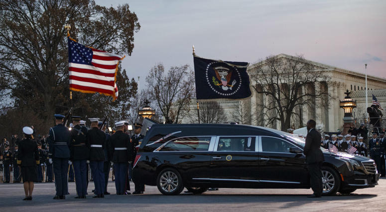 A joint services military honor guard removes the casket of former President George H.W. Bush from the hearse to carry it into the rotunda of the U.S. Capitol in Washington to lie in state, Monday, Dec. 3, 2018. A joint services military honor guard removes the casket of former President George H.W. Bush from the hearse to carry it into the rotunda of the U.S. Capitol in Washington to lie in state, Monday, Dec. 3, 2018.