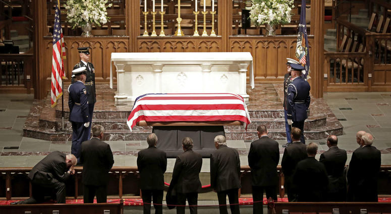 Visitors pay their respects to the flag-draped casket of former President George H.W. Bush at St. Martin's Episcopal Church Wednesday, Dec. 5, 2018, in Houston. Visitors pay their respects to the flag-draped casket of former President George H.W. Bush at St. Martin's Episcopal Church Wednesday, Dec. 5, 2018, in Houston.
