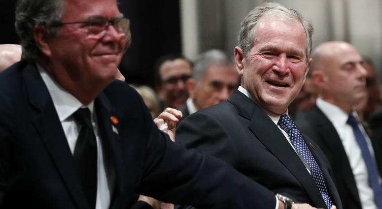 Former President George W. Bush smiles with his brother Jeb Bush at the state funeral for their father, former President George H.W. Bush, at the Washington National Cathedral on December 5, 2018 in Washington, DC. Former President George W. Bush smiles with his brother Jeb Bush at the state funeral for their father, former President George H.W. Bush, at the Washington National Cathedral on December 5, 2018 in Washington, DC.