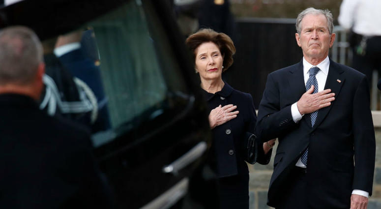 Former President George W. Bush and former first lady Laura Bush watch as the flag-draped casket of former President George H.W. Bush is carried by a joint services military honor guard to a State Funeral at the National Cathedral December 5, 2018. Former President George W. Bush and former first lady Laura Bush watch as the flag-draped casket of former President George H.W. Bush is carried by a joint services military honor guard to a State Funeral at the National Cathedral December 5, 2018.