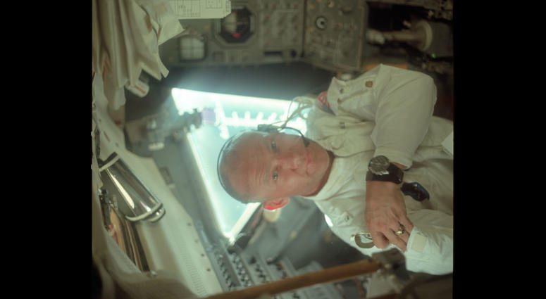 Buzz in the LM during its checkout en route to the Moon. He is on the left side of the cabin and is placing a pair of sunglasses in his jacket's arm pocket. Buzz in the LM during its checkout en route to the Moon. He is on the left side of the cabin and is placing a pair of sunglasses in his jacket's arm pocket.
