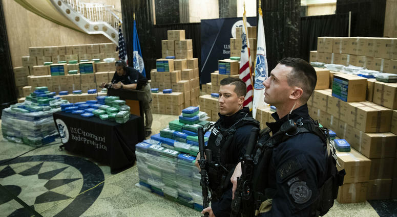 Officers stand guard over a fraction of the cocaine sized from a ship at a Philadelphia port is seen ahead of a news conference at the U.S. Custom House in Philadelphia, Friday, June 21, 2019. Officers stand guard over a fraction of the cocaine sized from a ship at a Philadelphia port is seen ahead of a news conference at the U.S. Custom House in Philadelphia, Friday, June 21, 2019.
