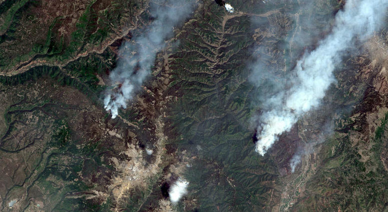 This June 9, 2018, satellite image provide by DigitalGlobe shows the 416 Fire, right, and the Burro Fire, left, northwest of Durango, Colo. 416 Fire, right, and the Burro Fire, left, northwest of Durango, Colo.