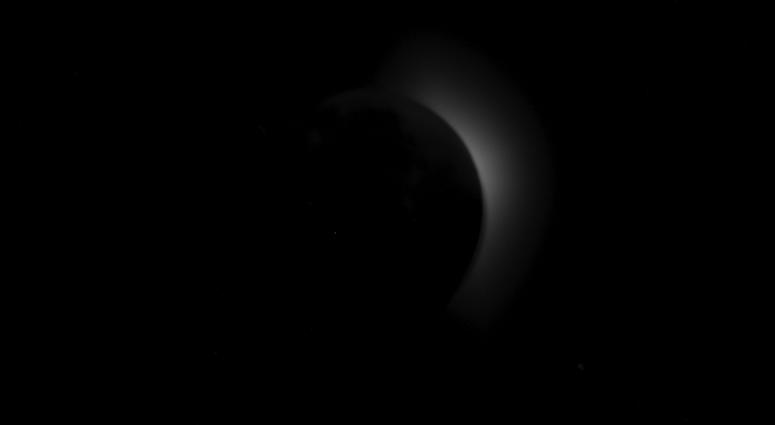 Solar corona appearing from behind the Moon. Lunar features appear to be visible illuminated by Earth's light, particularly Mare Imbrium and the ray systems of Copernicus and Kepler. Solar corona appearing from behind the Moon. Lunar features appear to be visible illuminated by Earth's light, particularly Mare Imbrium and the ray systems of Copernicus and Kepler.