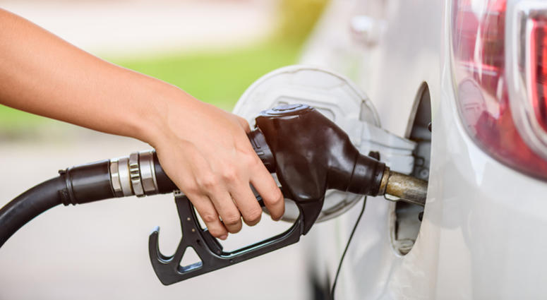 Woman pumping gasoline fuel in car at gas station. Woman pumping gasoline fuel in car at gas station.