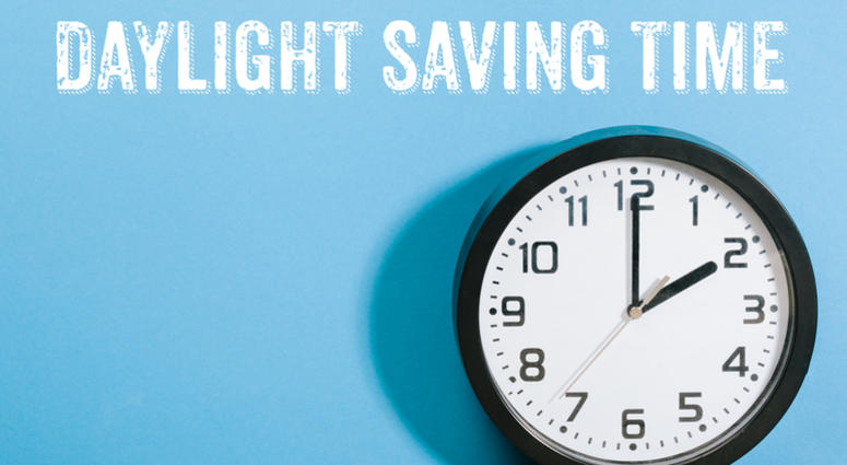 Daylight Saving Time written on wall behind clock turned to 2am Daylight Saving Time
