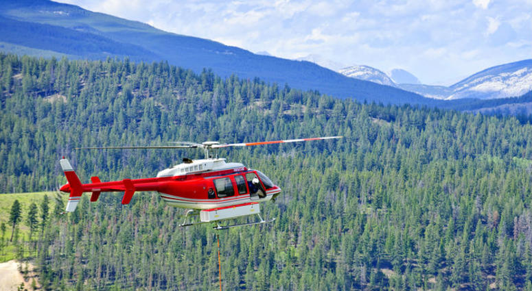 search and rescue helicopter flies over the mountains search and rescue