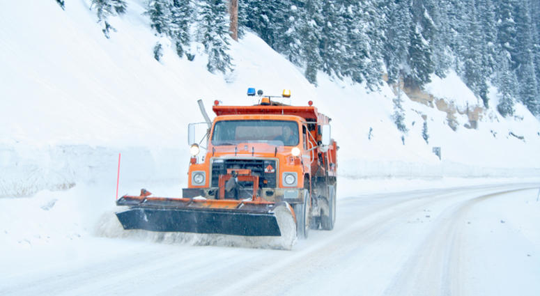 Snow plow removing snow from highway Snow Plow